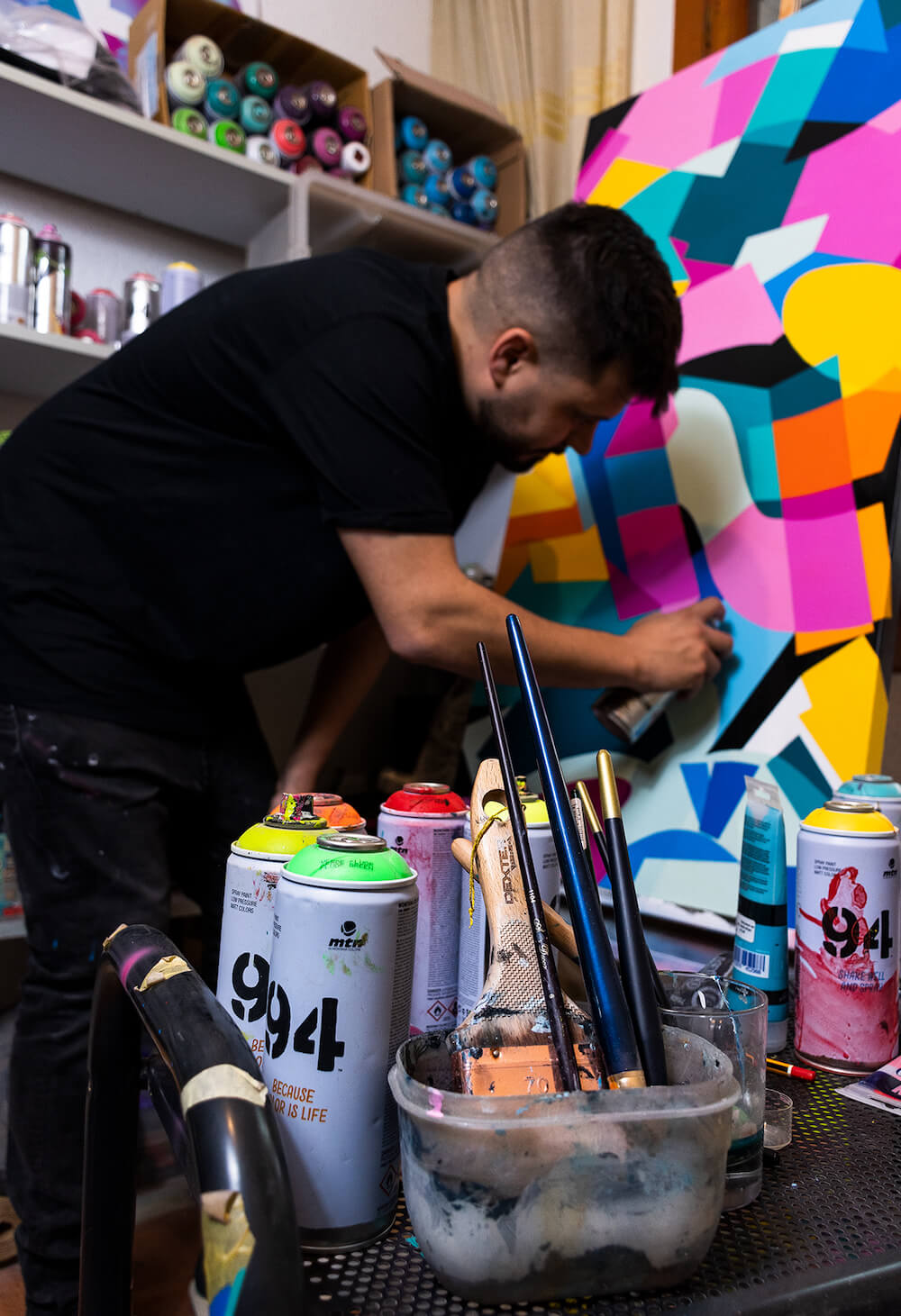 Manuel Forner Hize photographed with abstract graffiti artwork